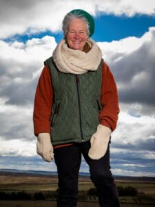 Shan Oakes wrapped up warm on a moor with moody clouds